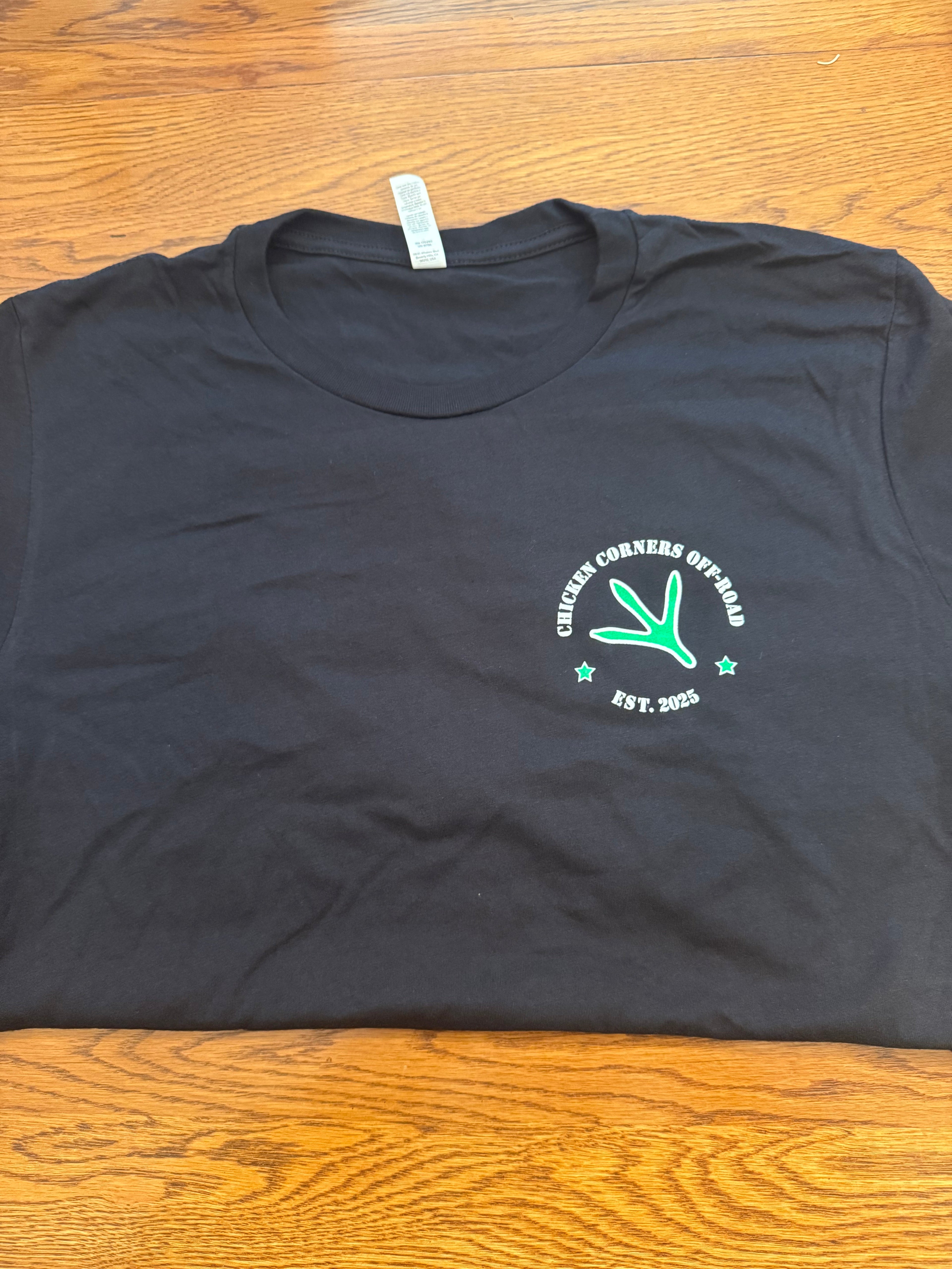 Black short sleeve logo T-shirt with green chicken corners logos on front and back